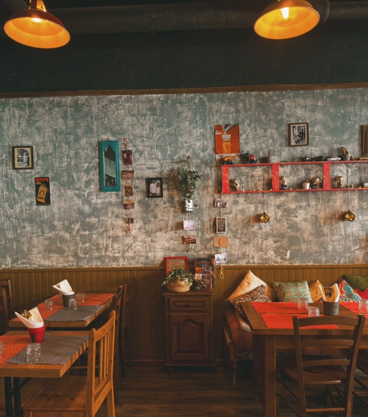 The dining room at Deb's Bistro, wooden tables under warm pendant lamps