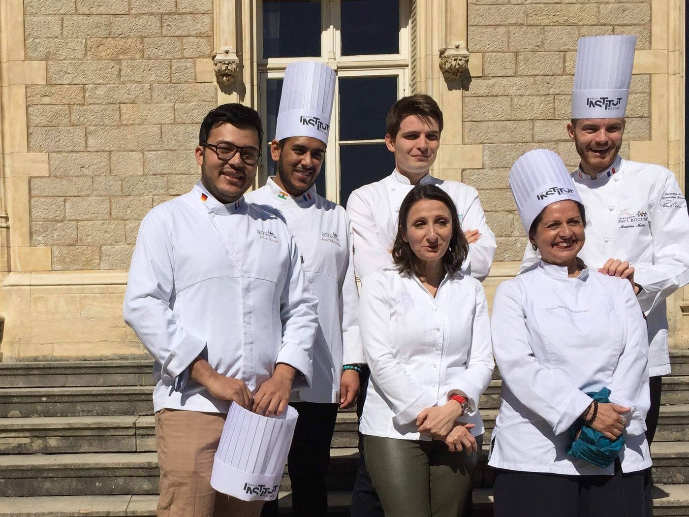 Chef Deb with his cohort in chef whites at Institut Paul Bocuse