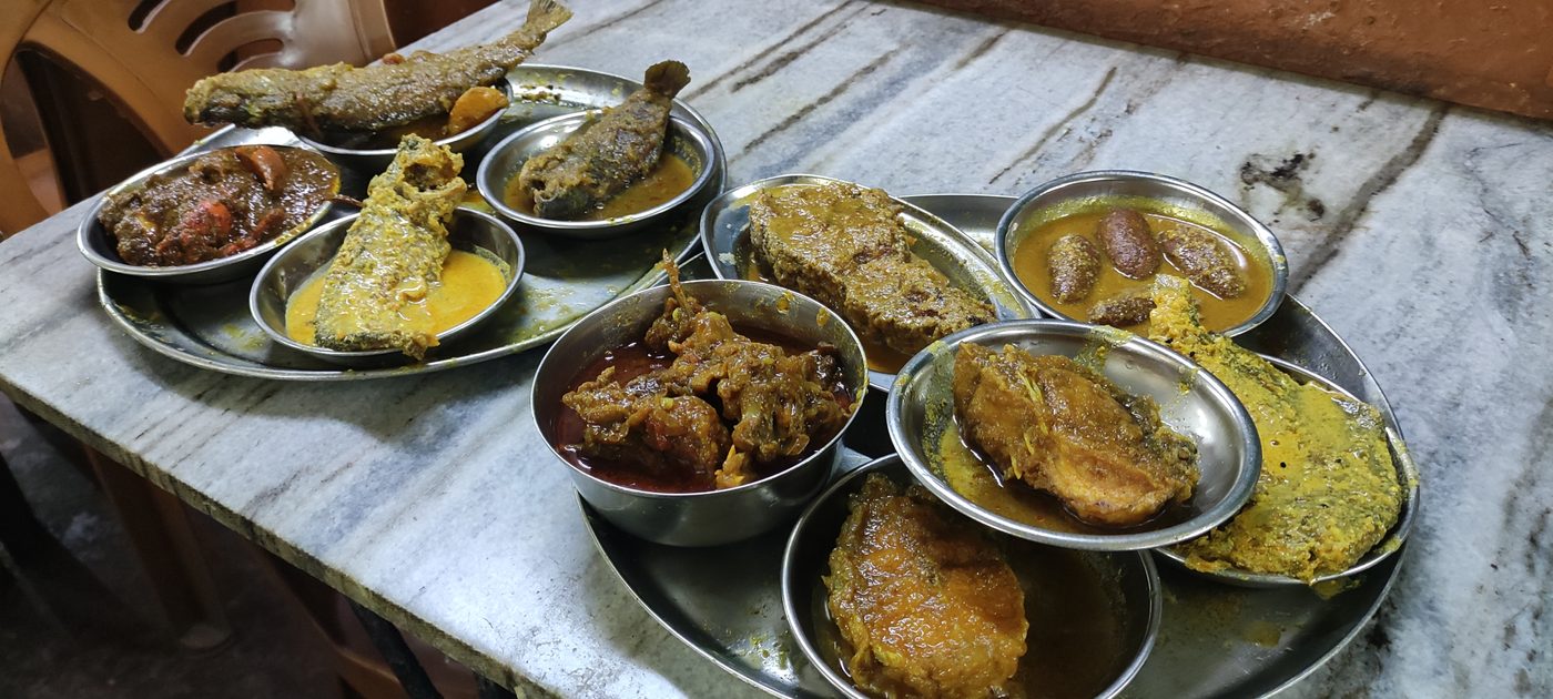 A full spread of dishes across a marble table